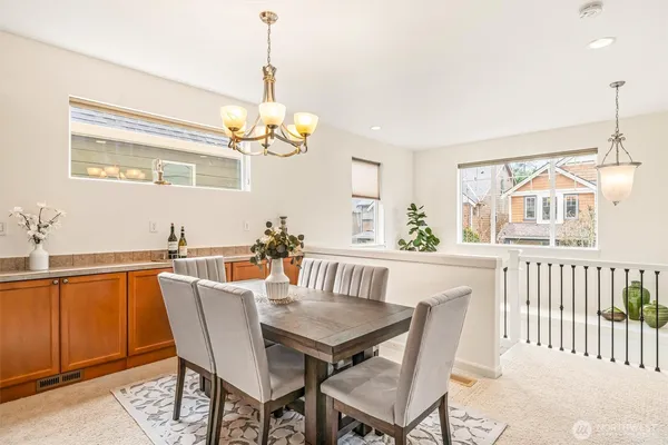a work room with a wooden floor and paintings on the wall