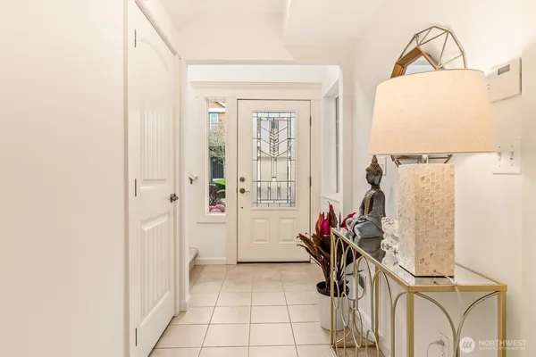 a view of a hallway to a livingroom with furniture