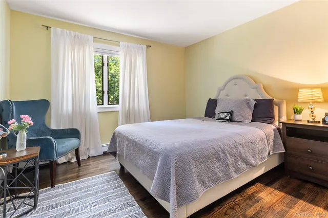 a bedroom with a bed a table and chair