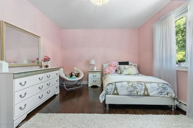 a bathroom with a tub shower sink and mirror