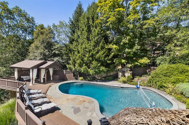 a view of a house with backyard and trees