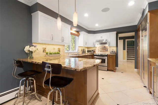 a kitchen with granite countertop cabinets and refrigerator