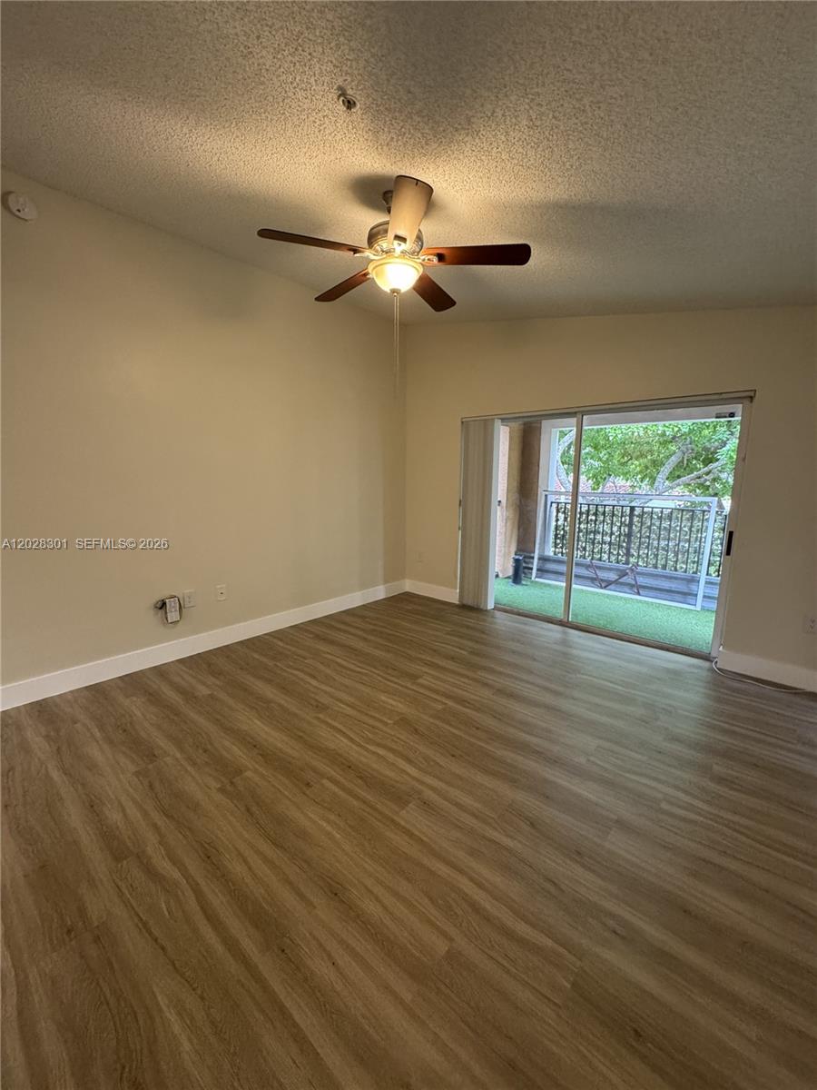 2021 Renaissance Boulevard, Unit 201 Miramar, FL 33025 - Photo 4 of 26 wooden floor in an empty room with a window