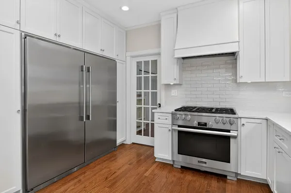 a kitchen with a stove and a refrigerator