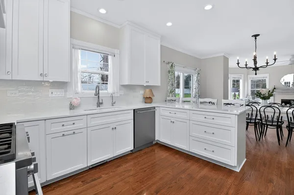 a kitchen with sink cabinets and wooden floor
