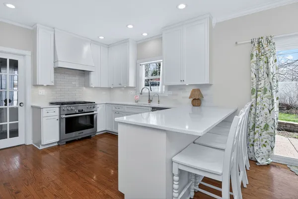 a kitchen with stainless steel appliances a stove a sink and a microwave