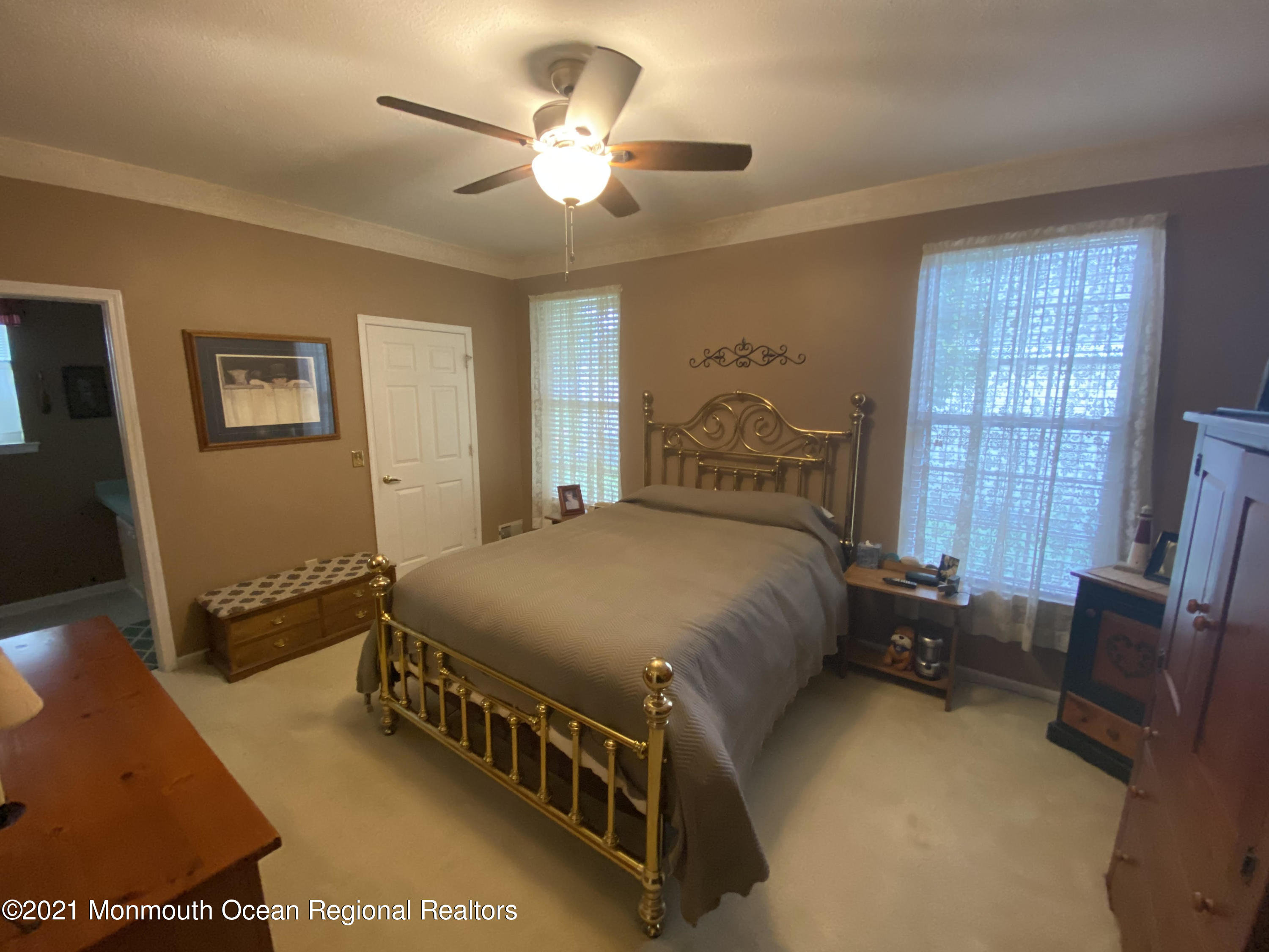 47 Sandpiper Road Barnegat, NJ 08005 - Photo 11 of 15 a bedroom with a bed a window and a chandelier