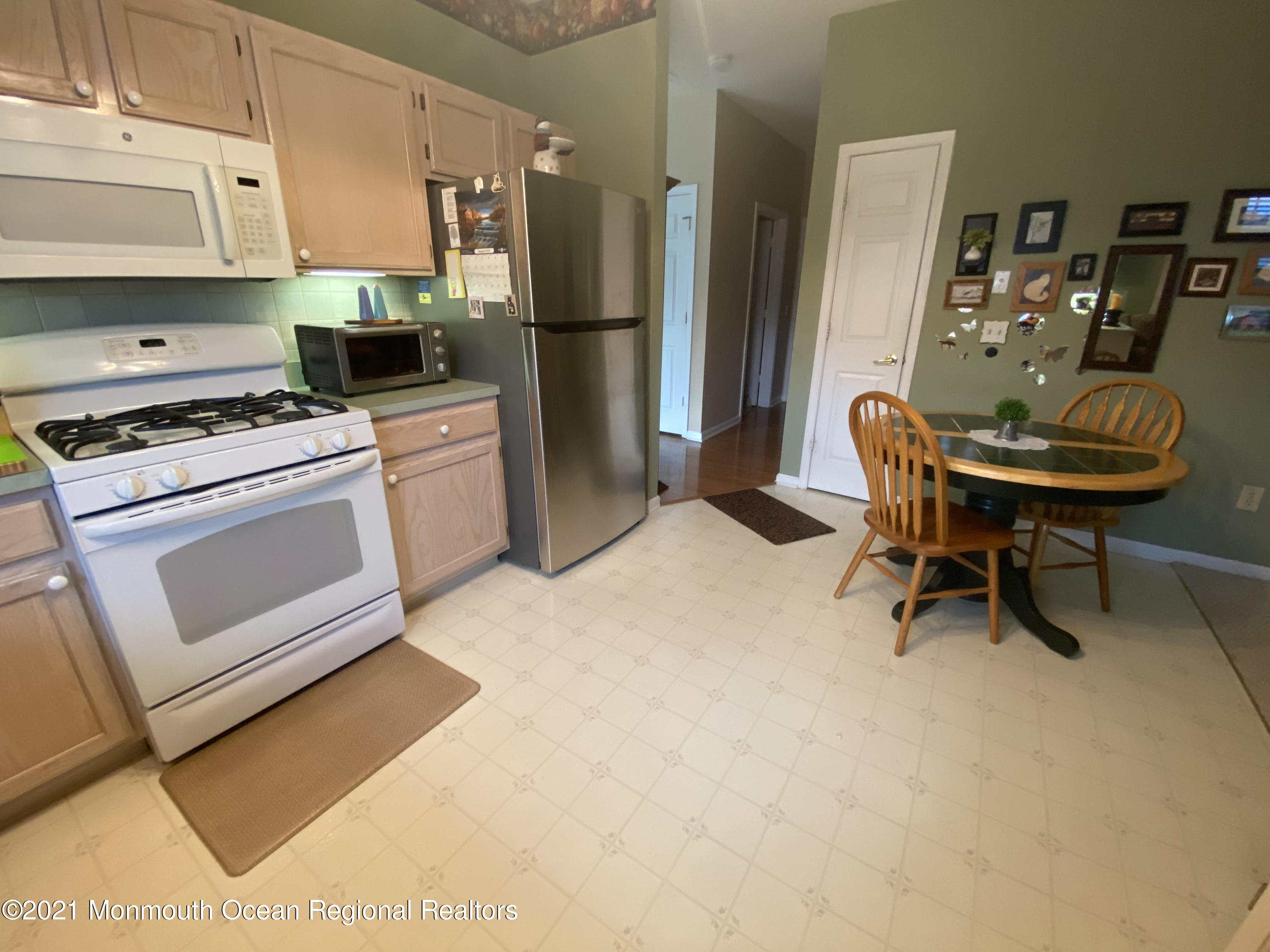 47 Sandpiper Road Barnegat, NJ 08005 - Photo 8 of 15 a kitchen with stainless steel appliances a stove a refrigerator a dining table and chairs
