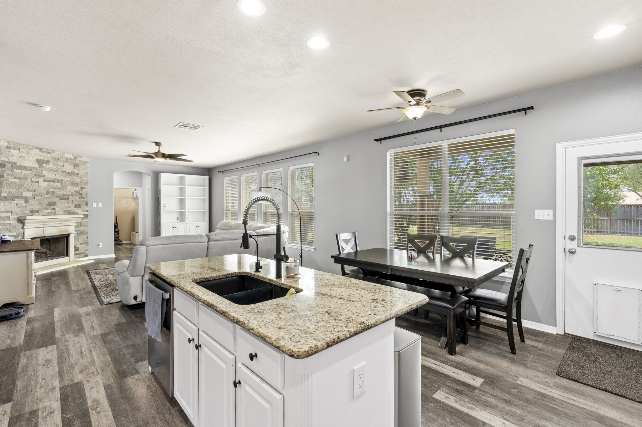 227 Sandstone Trail Buda, TX 78610 - Photo 8 of 33 Kitchen island with granite countertop and double basin sink