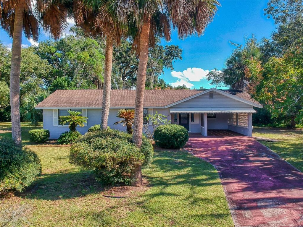 103 Floridana Road DeBary, FL 32713 - Photo 1 of 1 a front view of a house with yard and green space