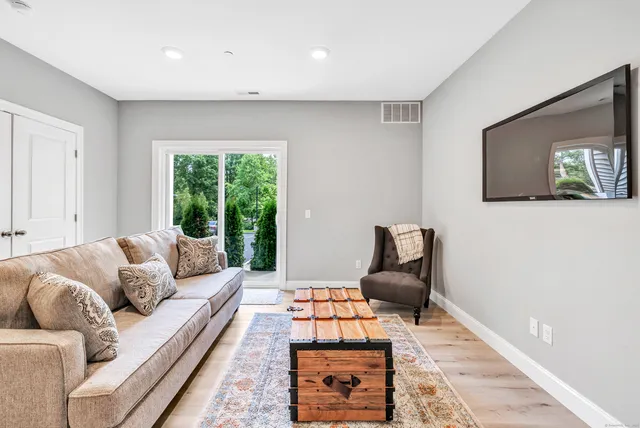 a living room with furniture rug and window