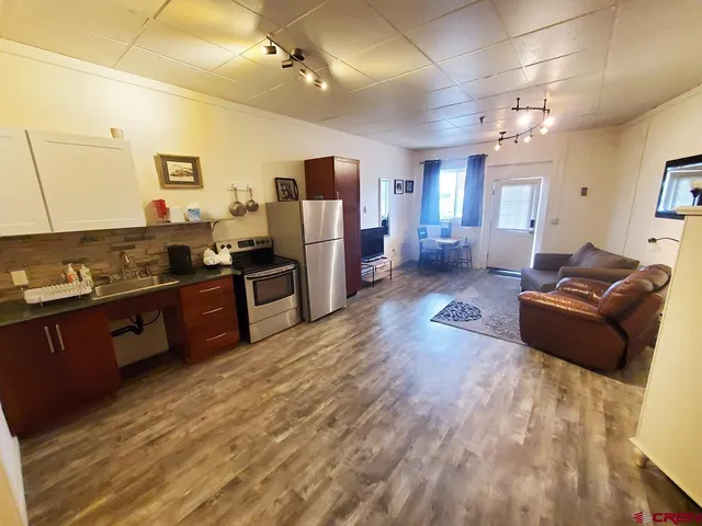 a living room with furniture windows and a flat screen tv