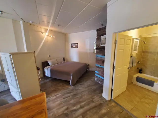 a bedroom with a bed and a couch