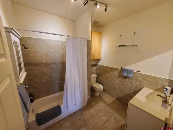 a bathroom with a shower and a sink