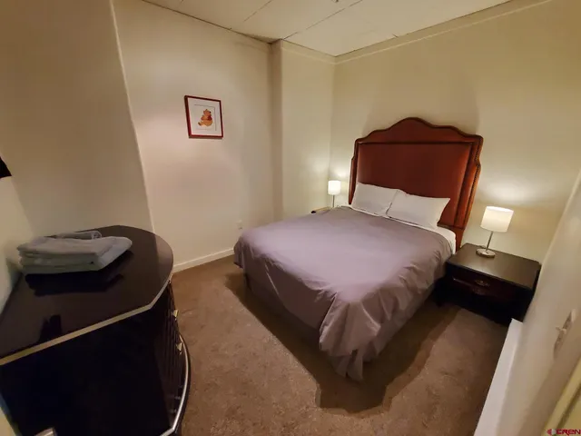 a bedroom with a bed and a mirror