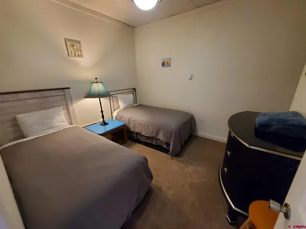 a bedroom with two beds and painted walls