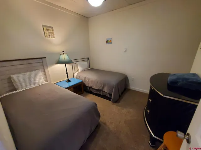 a bedroom with two beds and painted walls