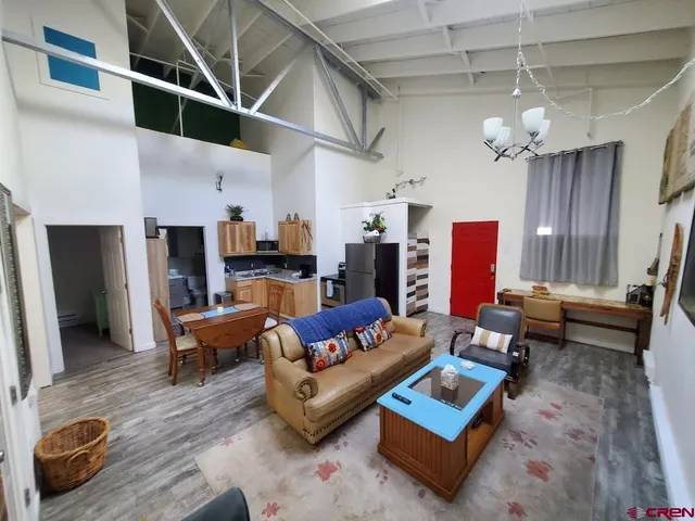 a living room with furniture and a chandelier