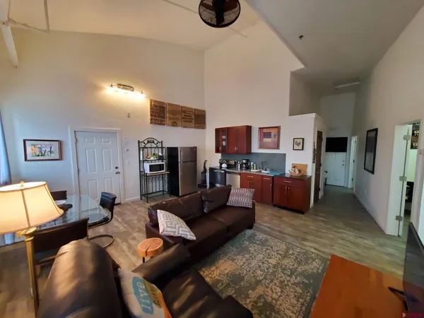 a living room with furniture kitchen view and a couch