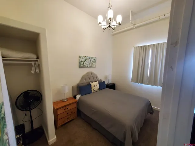 a bedroom with bed and window