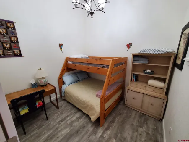 a bedroom with a bunk bed and a dresser in it