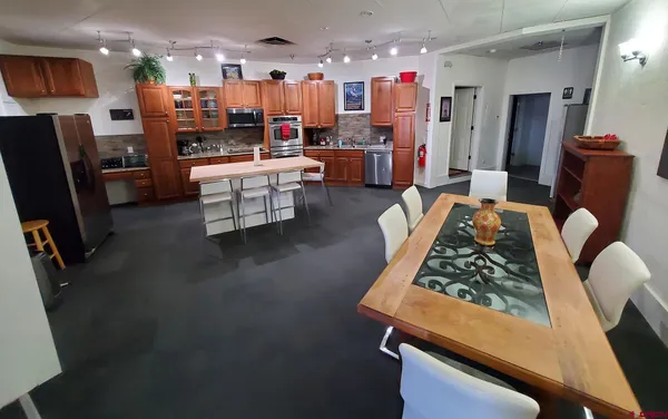 a living room with dining room and wooden floor