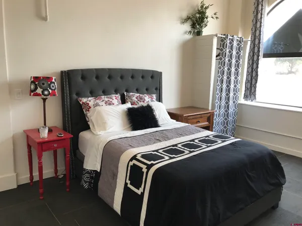 a bedroom with bed and window