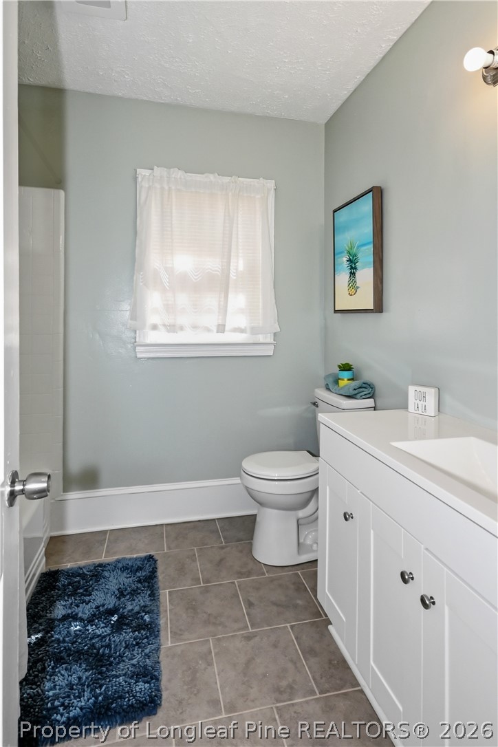 5307 Cypress Road Fayetteville, NC 28304 - Photo 11 of 36 a bathroom with a toilet a sink and a window