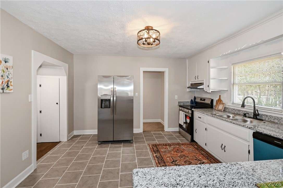 5307 Cypress Road Fayetteville, NC 28304 - Photo 12 of 36 a kitchen with stainless steel appliances granite countertop a sink stove and refrigerator