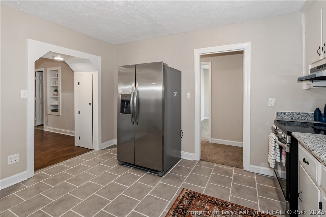 5307 Cypress Road Fayetteville, NC 28304 - Photo 14 of 36 a view of a refrigerator in kitchen and an empty room