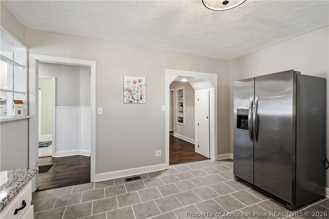 5307 Cypress Road Fayetteville, NC 28304 - Photo 16 of 36 a view of a refrigerator in kitchen and an empty room