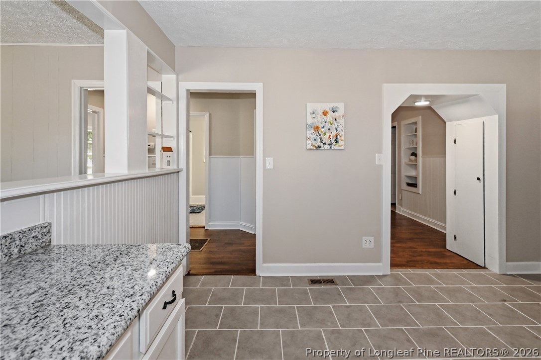 5307 Cypress Road Fayetteville, NC 28304 - Photo 17 of 36 hallway with wooden floor and chandelier