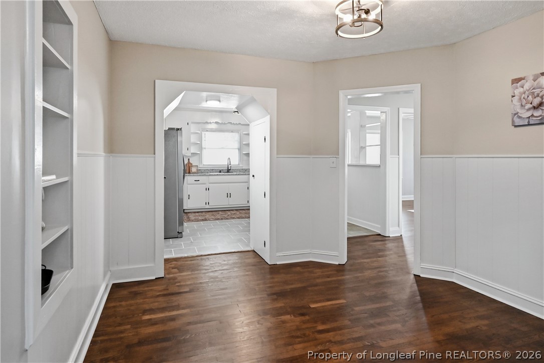 5307 Cypress Road Fayetteville, NC 28304 - Photo 18 of 36 a view of a hallway with wooden floor and a bathroom