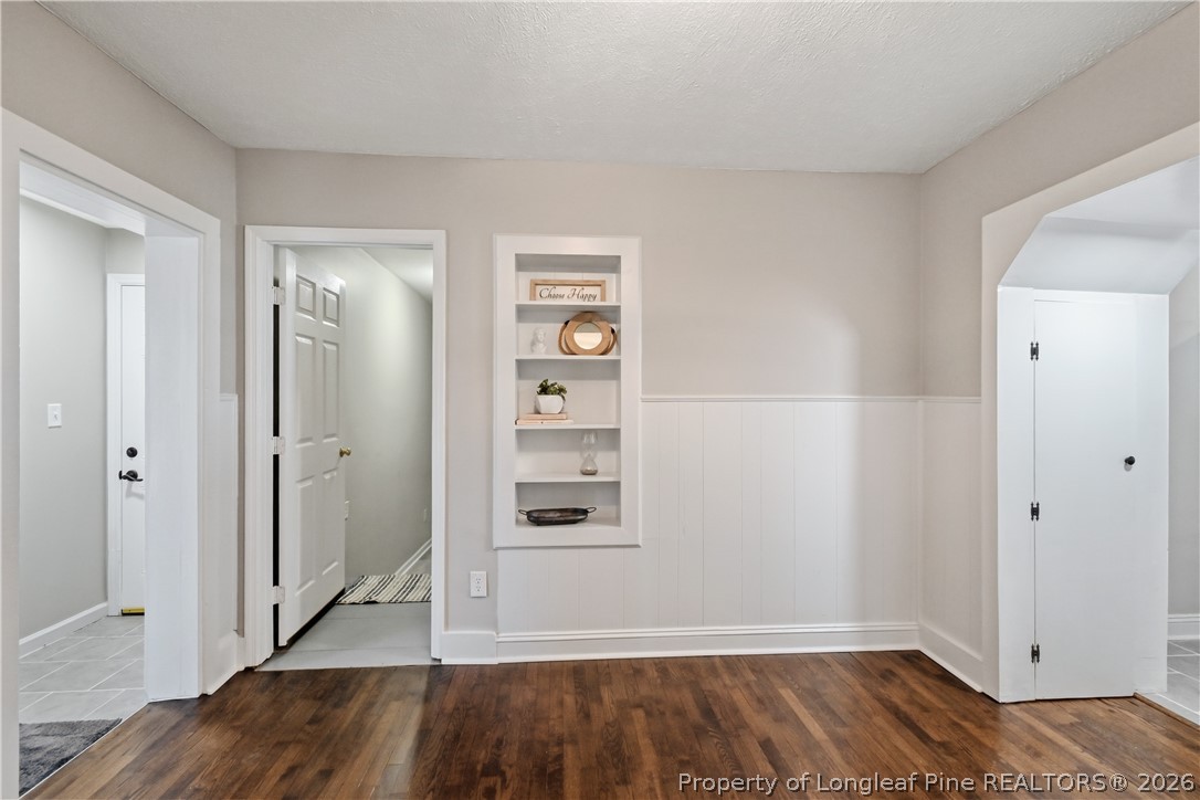 5307 Cypress Road Fayetteville, NC 28304 - Photo 19 of 36 an empty room with wooden floor closet and windows