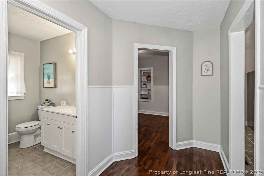 5307 Cypress Road Fayetteville, NC 28304 - Photo 10 of 36 a view of bathroom with a toilet a sink and a mirror