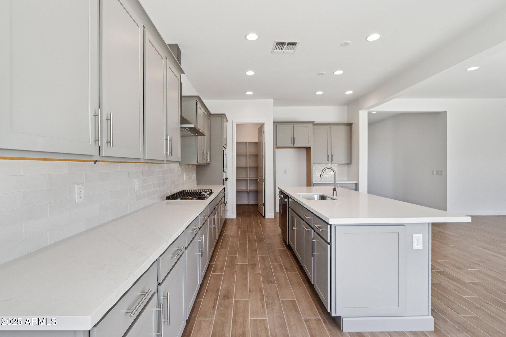 11417 East Utah Avenue Mesa, AZ 85212 - Photo 13 of 55 a large kitchen with stainless steel appliances sink a microwave and cabinets