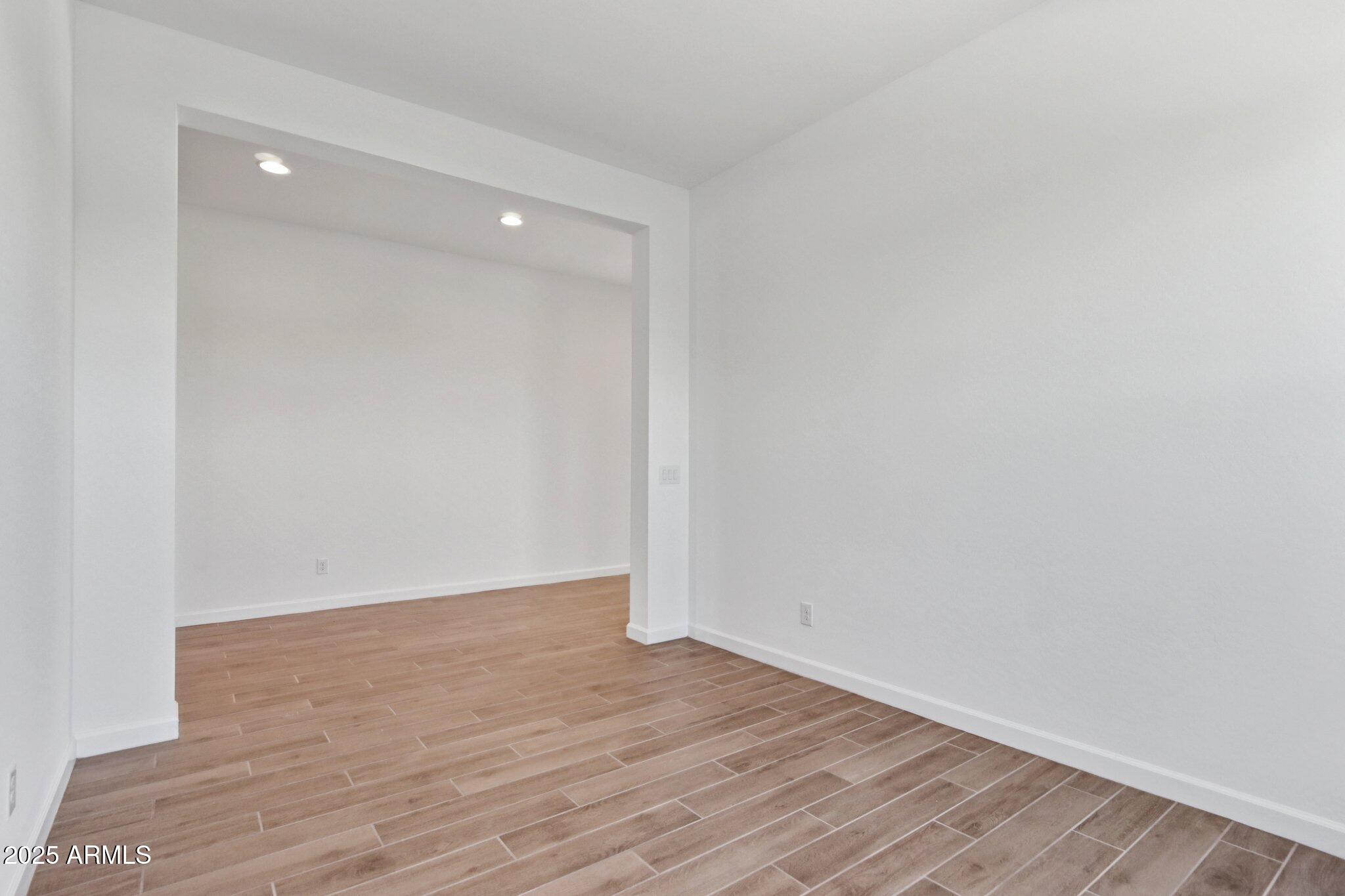 11417 East Utah Avenue Mesa, AZ 85212 - Photo 16 of 55 a view of an empty room with wooden floor
