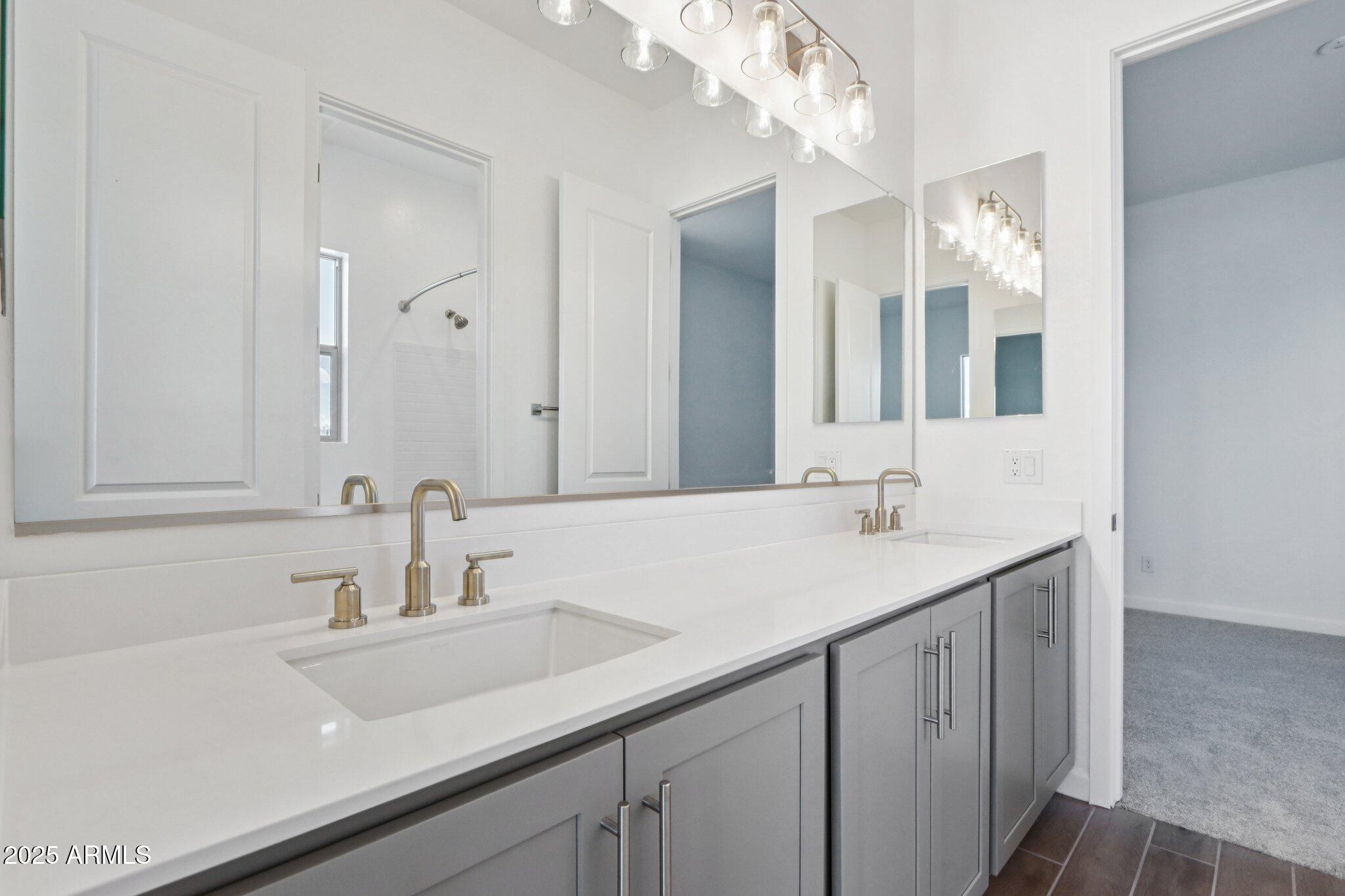 11417 East Utah Avenue Mesa, AZ 85212 - Photo 21 of 55 a bathroom with a sink and a mirror