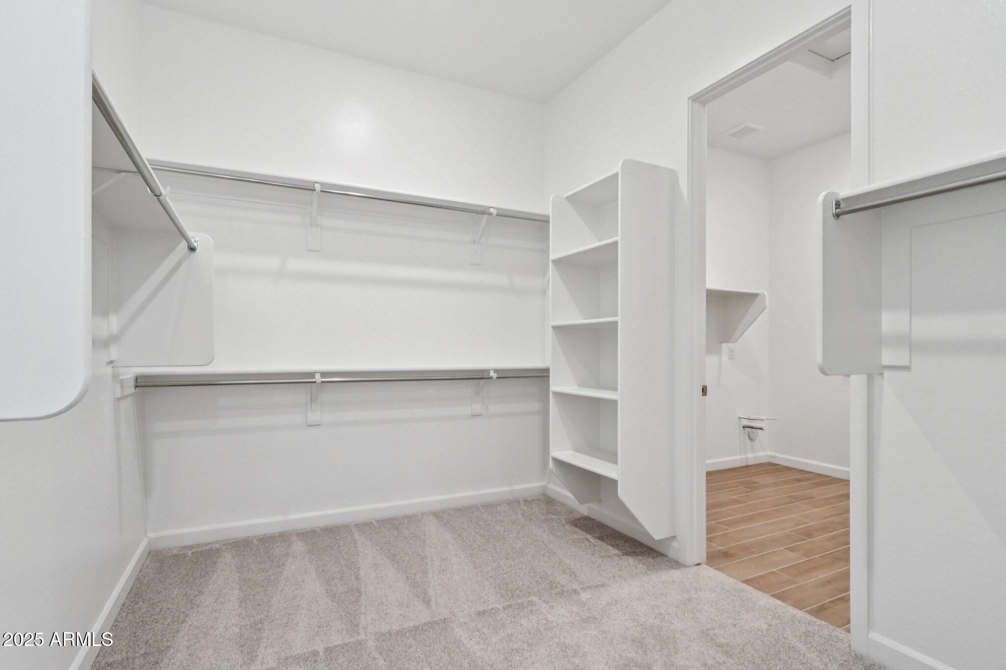 11417 East Utah Avenue Mesa, AZ 85212 - Photo 28 of 55 a view of walk in closet with empty racks