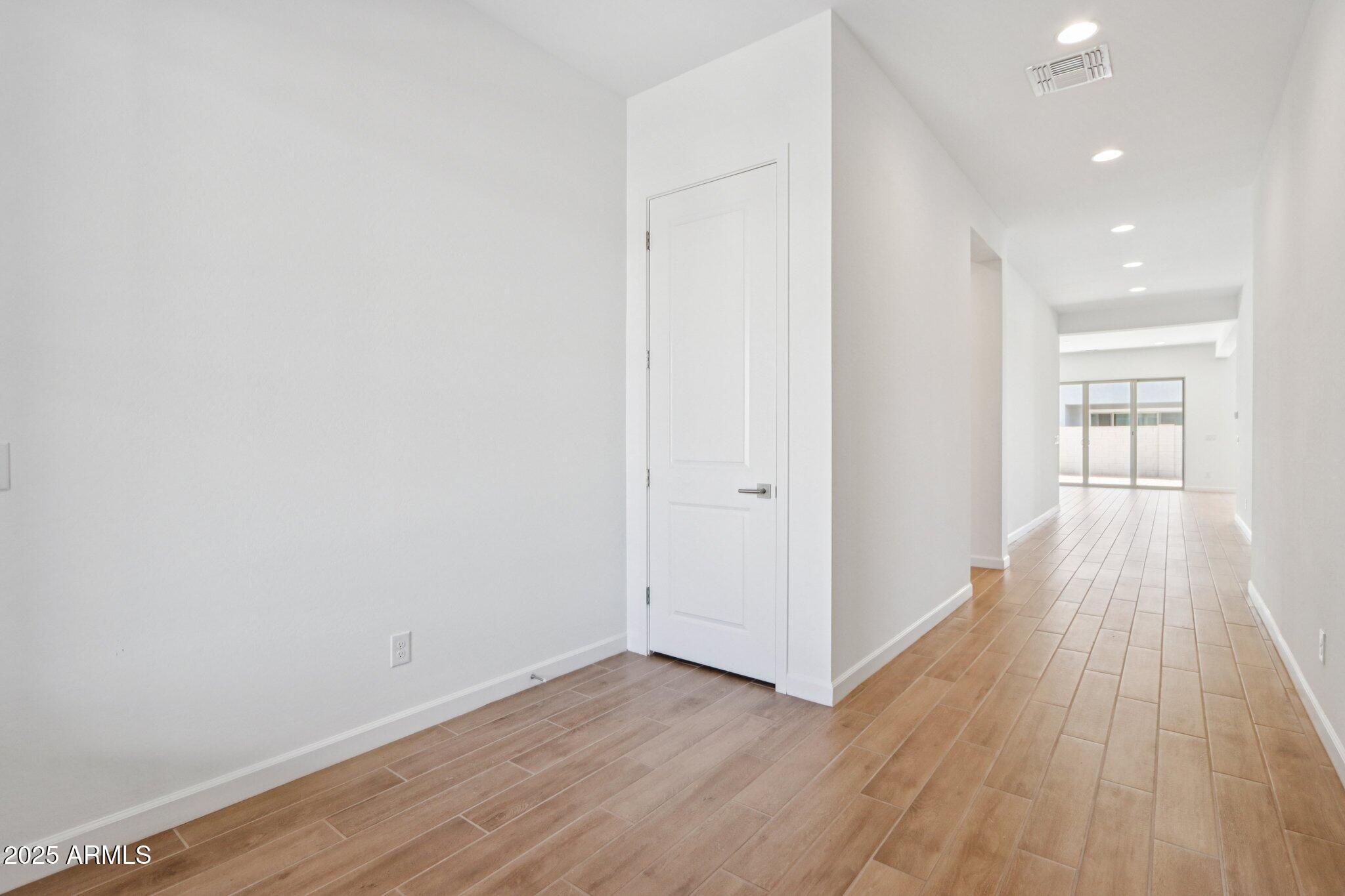 11417 East Utah Avenue Mesa, AZ 85212 - Photo 6 of 55 wooden floor in an empty room with a window