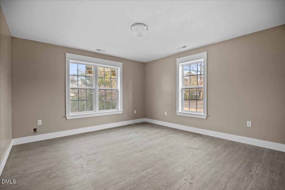 413 South Main Street Princeville, NC 27886 - Photo 14 of 21 a view of an empty room with a window and wooden floor