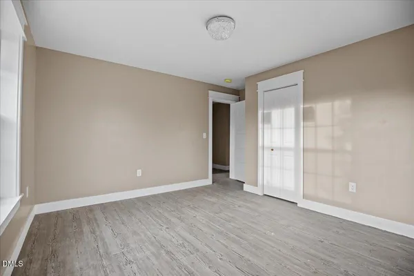 a view of an empty room with wooden floor