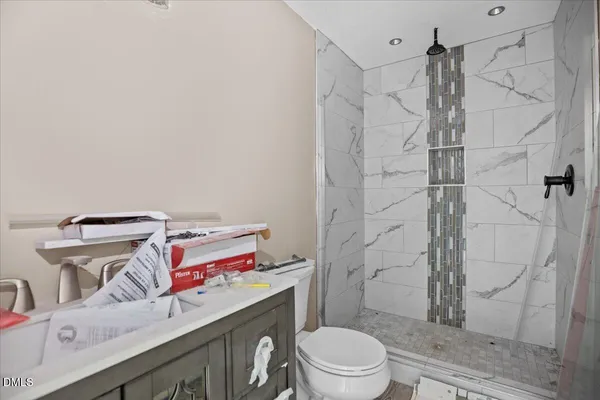 a bathroom with a sink toilet and shower