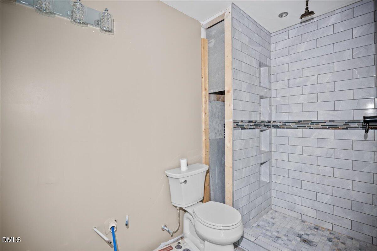 413 South Main Street Princeville, NC 27886 - Photo 17 of 21 a white toilet sitting next to a shower