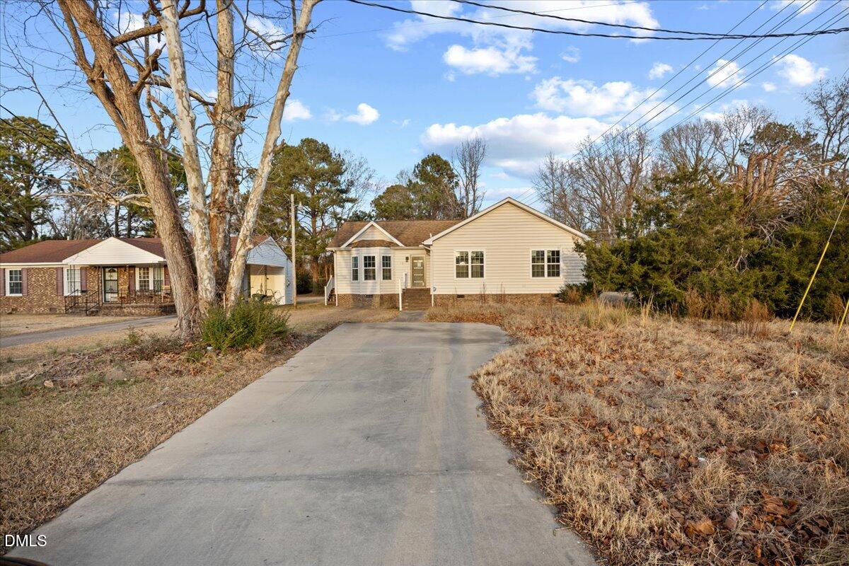 413 South Main Street Princeville, NC 27886 - Photo 2 of 21 a view of white house with a yard and wooden fence