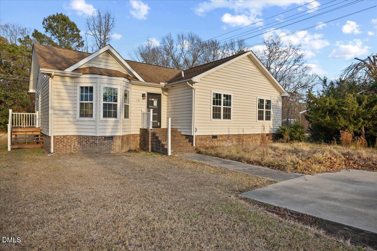 413 South Main Street Princeville, NC 27886 - Photo 3 of 21 a front view of a house with a yard and garage