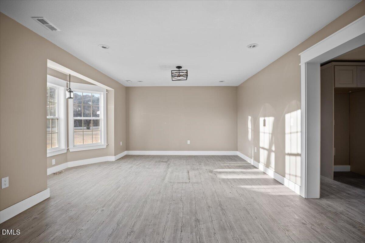 413 South Main Street Princeville, NC 27886 - Photo 5 of 21 a view of an empty room with wooden floor and a window