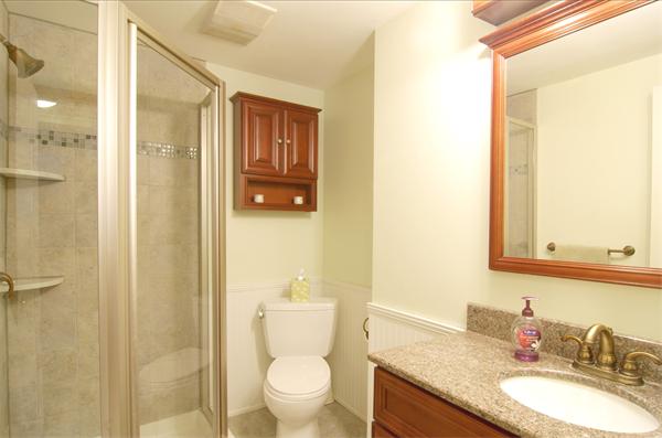 253 Liberty Square Road Boxborough, MA 01719 - Photo 17 of 21 a bathroom with a granite countertop sink toilet and shower