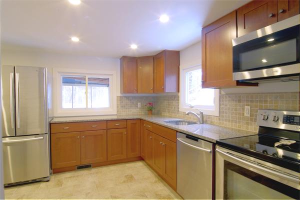 253 Liberty Square Road Boxborough, MA 01719 - Photo 5 of 21 a kitchen that has a sink and a stove in it