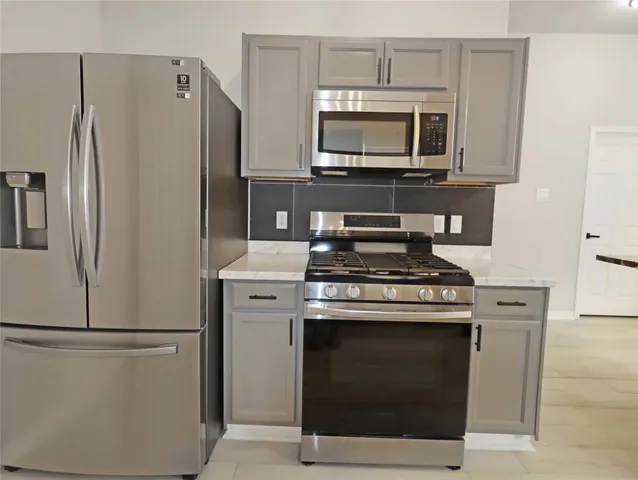 a kitchen with a stove microwave and refrigerator